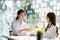 Two women shake hands, two businesswomen shake hands as they meet to discuss brainstorming and marketing plans to find more