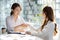 Two women shake hands, two businesswomen shake hands as they meet to discuss brainstorming and marketing plans to find more