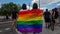 Two women share a rainbow flag on Christopher Street Day CSD in Berlin