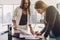 Two women signing a contract standing in modern appartment