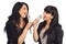Two women singing to microphones