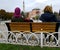 Two women sit in front of the fountain of Sultan ahmet Square and look at the Hagia Sophia