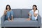 Two women sitting on the livingroom watching horror movie looki