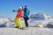 Two women skiers posing at Sass Pordoi Pordoi peak, with Piz Boe mountain peak in the background, during a break