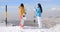 Two women snowboarders enjoying the winter view