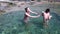 Two women splashing in water