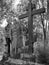Two women stand next to a wooden cross