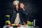 Two women start to prepare vegetable juice in a blender.