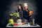 Two women start to prepare vegetable juice in a blender.