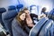 Two women taking a selfie together while traveling on an airplane