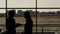 Two women are talking in the airport waiting hall standing