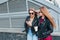 Two Women Talking in the City.Outdoor lifestyle portrait of two best friends hipster girls wearing stylish Leather