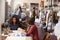 Two women talking at a table in a clothes design studio