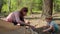 Two women and two boys having summer camping vacation in forest. Happy family of two mothers and two sons put up tent