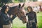 two women veterinarian and owner enjoying with a horse outdoors at ranch