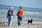 Two women walk with dog