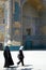 Two women walk past the Shrine of Khwaja Abu Nasr Parsa or Green Mosque in Balkh, Afghanistan