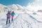 Two women walk with snowshoes on the backpacks in winter trekking