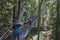 Two women walk on a suspended bridge on the greenheart treewalk at UBC