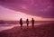 two women walking on beach near water during sunset time while sun sets