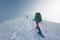 Two women on a winter hike. Girlfriends with trekking sticks go along a snow-covered mountain path. Girls with backpacks and