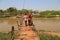 Two women on a wooden bridge in Myanmar