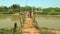 Two women on a wooden bridge in Myanmar