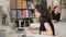 Two women work in office next to computers indoors