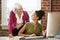 Two Women Working At Computer In Contemporary Office