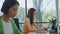 Two women working computers panoramic window office closeup. Lady sipping coffee