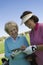 Two women writing in score card on golf course