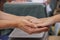 Two womens hands reaching from either side exchanging coins - paying for something - blurred background selective focus - room for