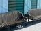 Two wood metal vintage benches on old house facade background