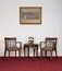 Two wooden armchairs, small round coffee table and telephone set
