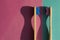 Two wooden bamboo toothbrushes on pink and blue background. A new personal dental hygiene concept in toothbrushes. Eco