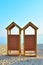 Two wooden beach changing rooms