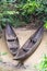 Two wooden canoes on the shore