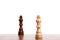 Two wooden chess pieces, black and white king on the board. Strategy, isolated on white background