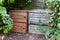 Two wooden compost bin in family garden home