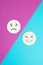 Two wooden faces one is sad the other one is smiling, positive and negative emotions, rating concept