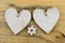 Two wooden hearts with on old wood holding with rope