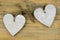 Two wooden hearts with on old wood holding with rope