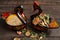 Two wooden painted swan-like dishes. One with wheat, other with dried fruits