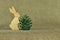 Two wooden rabbit holding a bump tree on eco-friendly fabric.