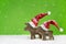 Two wooden reindeer: funny green and white christmas background.