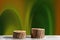 Two wooden round saw cuts on a fantasy green-orange background. Natural podiums for advertising cosmetic products and