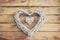 Two wooden rustic decorative hearts hanging on vintage wooden
