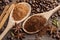 Two wooden spoons with ground coffee and ground cinnamon.