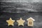 Two wooden stars and a house. Two star hotel or restaurant. Review of the critic. Quality of service and level of service. Rating