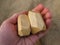 Two wooden stones for tumi ishi toy on a man`s palm